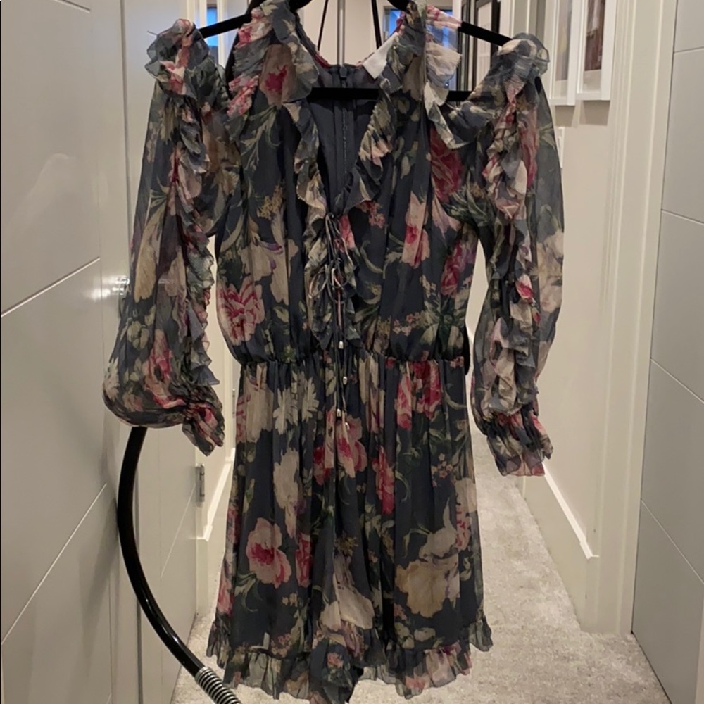 Zimmermann Floral Ruffle Long Sleeve Romper in Charcoal with Pink & Cream Blooms